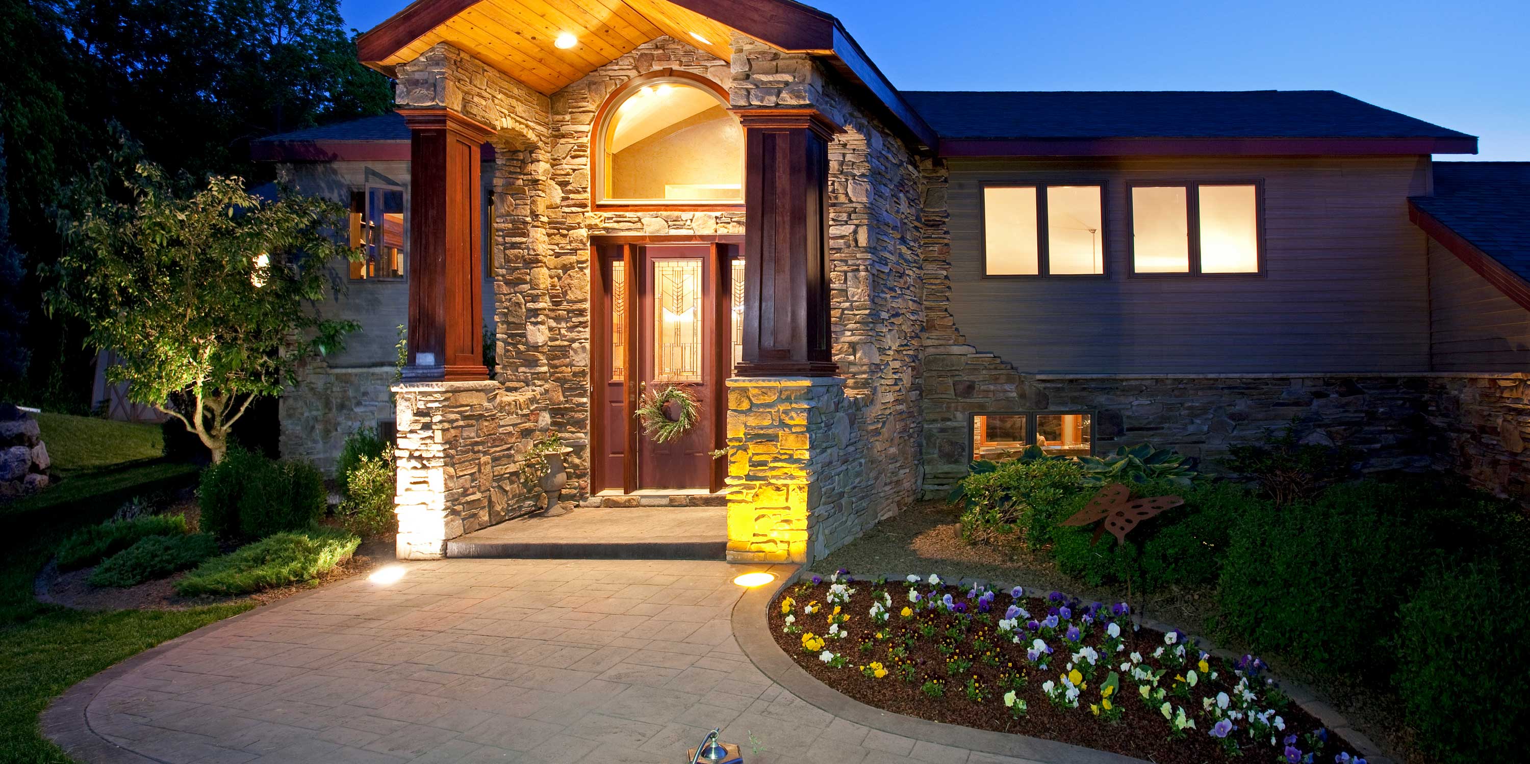 Lighted entryway, home, brick and wood, wreath on wooden door