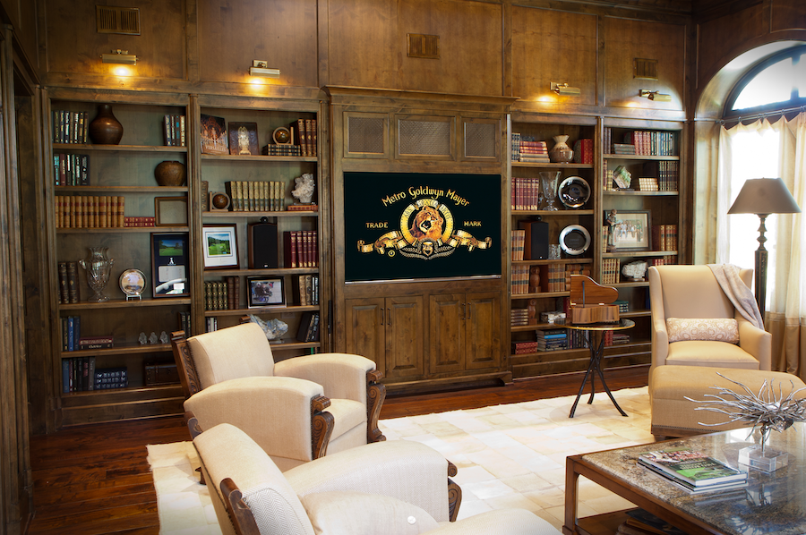 A luxurious home theater with the Metro Goldwyn Meyer lion on it. 